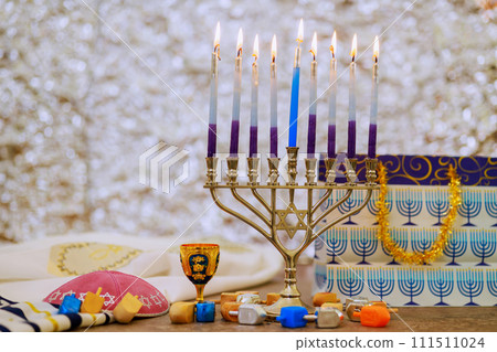 Hanukkah Menorah with burning candles is Jewish holiday symbol Hanukkah Menorah with burning candles is Jewish holiday symbol 111511024