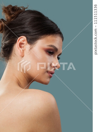 Good-looking cheerful woman brunette with natural make-up, healthy clean fresh skin and wavy hair 111511336