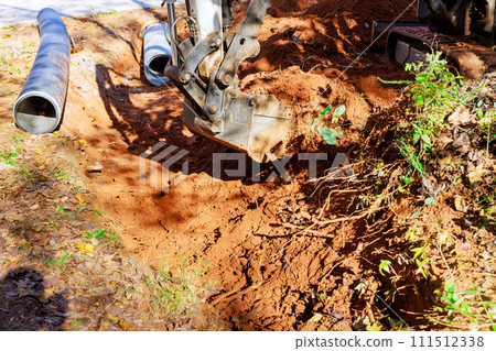 Excavators dig trenches for laying of pipe through which rainwater will be collected 111512338