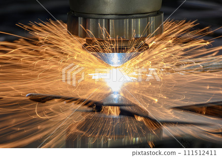 Close up  scene the fiber laser cutting machine  cut the metal plate with the sparkling light. 111512411
