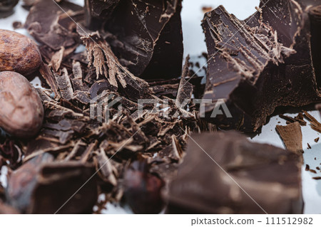 Cocoa beans with chocolate on a white background. Shalllow dof. Cocoa beans with chocolate on a white background. Shalllow dof. 111512982
