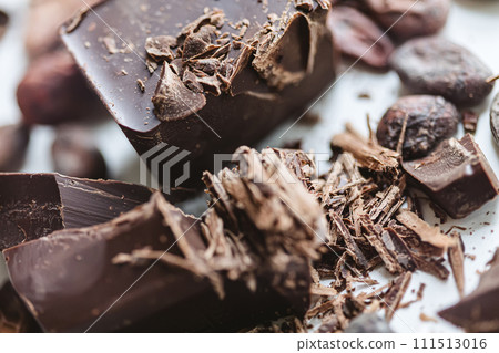 Cocoa beans with chocolate on a white background. Shalllow dof. Cocoa beans with chocolate on a white background. Shalllow dof. 111513016