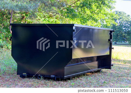 Located on construction site is metal container dumpster that is used to dispose of repair junk waste 111513050