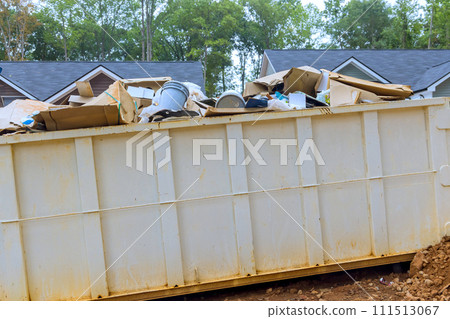 Metal container dumpster is available at construction site for disposal of repair junk waste Metal container dumpster is available at construction site for disposal of repair junk waste 111513067