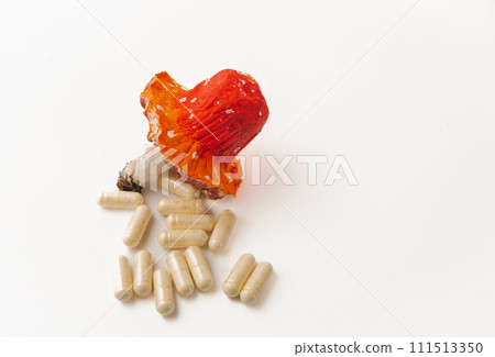 Capsules, tincture, poisonous mushrooms fly agarics with a red hat on a wooden table, flat layout. Supplements, medicinal plant amanita muscaria for use in herbal medicine, homeopathy and cosmetology 111513350