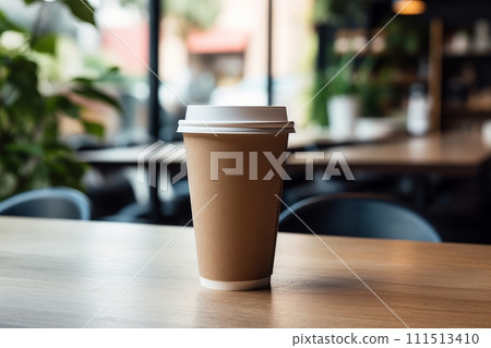 Paper takeaway coffee cup with a lid in a cafe on the wooden table 111513410