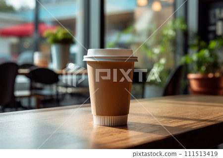 Paper takeaway coffee cup with a lid in a cafe on the wooden table Paper takeaway coffee cup with a lid in a cafe on the wooden table 111513419