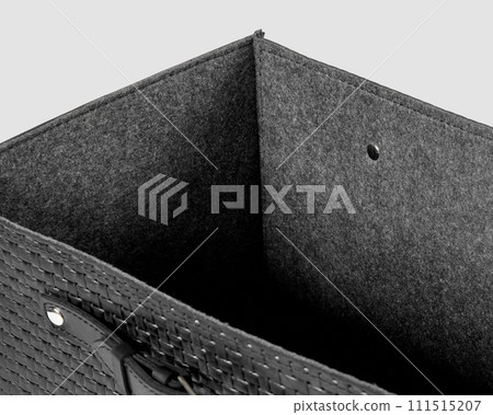 Closeup of black leather woven box with gray felt lining Closeup of black leather woven box with gray felt lining 111515207