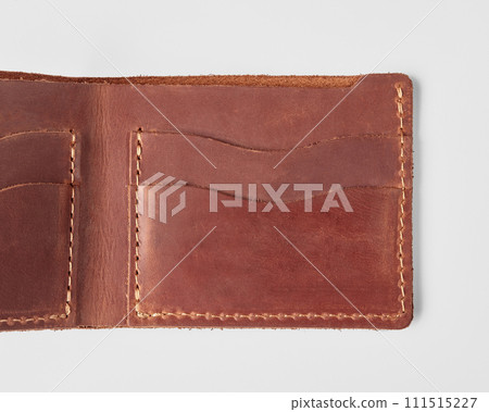 Open brown leather wallet with card pockets and hidden embossed message 111515227