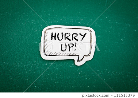 Hurry up. Speech bubble with text on a green chalkboard Hurry up. Speech bubble with text on a green chalkboard 111515379