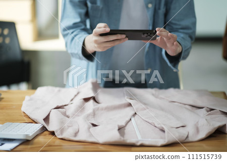 Online Business Owner Photographing Apparel for SaleOnline Business Owner Photographing Apparel for Sale. 111515739