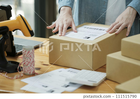Scanning Barcode on Shipping Box with Scanner 111515790