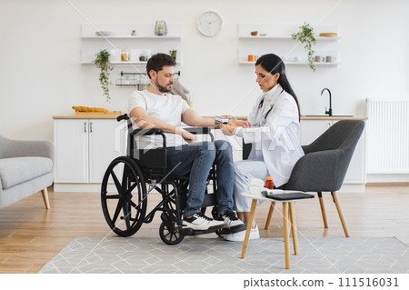 Cardiologist telling patient with disability about all reasons of hypertension. 111516031
