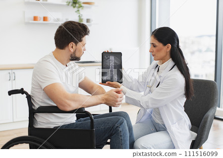 Caucasian woman doctor checking up condition of mature male patient at home. 111516099