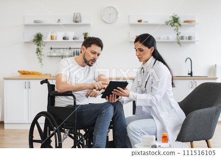 Caucasian female doctor checking up condition of bearded male patient at home. 111516105