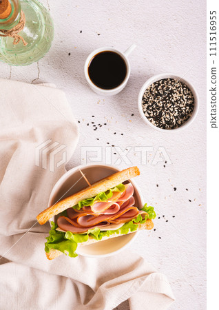 Toast sandwich with ham, cheese and herbs in a bowl on the table top and vertical view 111516955