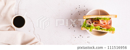 Toast sandwich with ham, cheese and herbs in a bowl on the table top view web banner 111516956