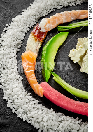 Colorful semicircle of ingredients for making sushi on black background 111516988