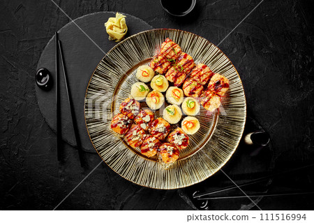 Luxury baked sushi rolls platter for two on stone table Luxury baked sushi rolls platter for two on stone table 111516994