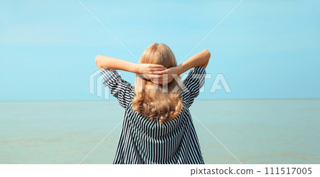 Summer vacation, happy relaxing woman meditates on the beach on sea 111517005