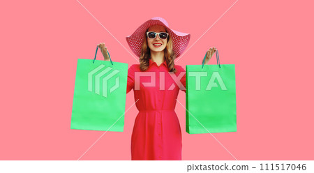 Beautiful happy smiling young woman model posing with shopping bags in summer hat Beautiful happy smiling young woman model posing with shopping bags in summer hat 111517046