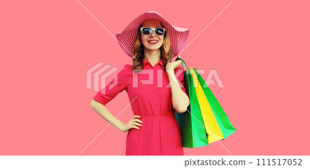 Beautiful happy smiling young woman model posing with shopping bags in summer hat Beautiful happy smiling young woman model posing with shopping bags in summer hat 111517052