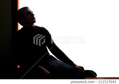Young man with grief dropped his arms and looking up 111517643