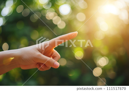 Woman's finger point to empty space on blurred nature background. Generative AI 111517870