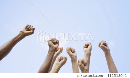 Different fists of people waving in the air Different fists of people waving in the air 111518041