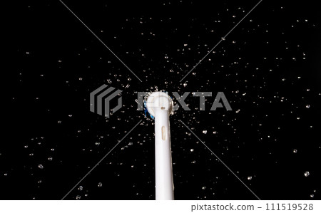 Electronic Brush spin with droplet splash around. Water Droplet splash all around electronic brush. Black background isolated, brush blur focus on water 111519528