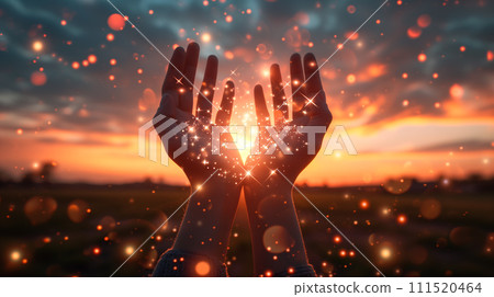 Open hands reaching towards a mesmerizing sunset, with particles of light floating around, creating a sense of magic and wonder. 111520464