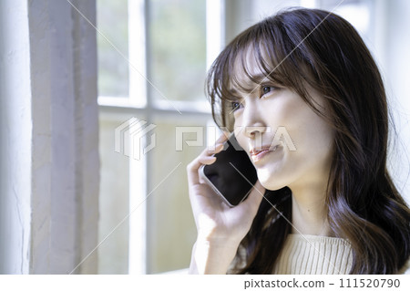 Women calling on a smartphone Women calling on a smartphone 111520790