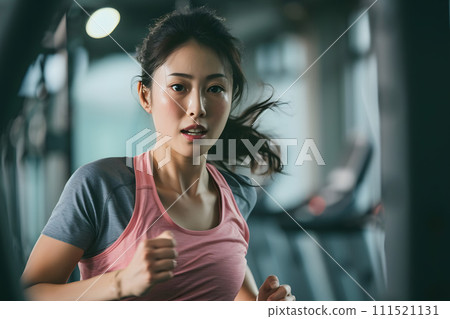 Asian woman running concentrated at the gym Asian woman running concentrated at the gym 111521131
