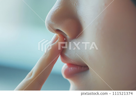 Asian woman pointing to her nose 111521374