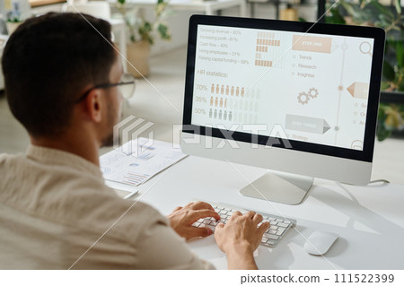 Young HR manager typing on keyboard Young HR manager typing on keyboard 111522399