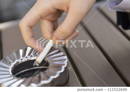Ashtray cigarette man's hand 111522699