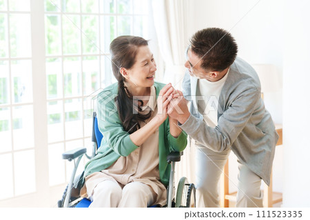 Middle-aged and elderly couple in wheelchairs Middle-aged and elderly couple in wheelchairs 111523335