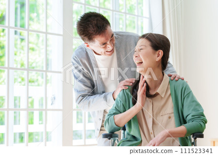 Middle-aged and elderly couple in wheelchairs Middle-aged and elderly couple in wheelchairs 111523341
