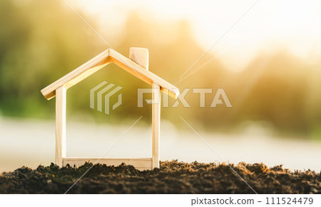 Wooden model house place on the soil. concept of real estate investment. planning savings money of coins to buy a home concept for property, mortgage and real estate investment. Wooden model house place on the soil. concept of real estate investment. planning savings money of coins to buy a home concept for property, mortgage and real estate investment. 111524479