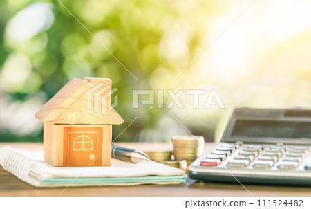 House placed on coins. notebook and pen Prepare planning savings money of coins to buy a home concept for property ladder, mortgage and real estate investment. House placed on coins. notebook and pen Prepare planning savings money of coins to buy a home concept for property ladder, mortgage and real estate investment. 111524482