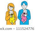 A couple holding a baby with a pacifier in its mouth 111524776