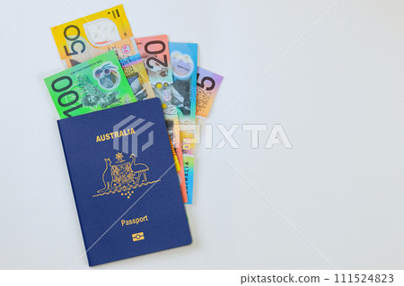Money Australian currency dollars cash banknotes in Australian passport on white background 111524823