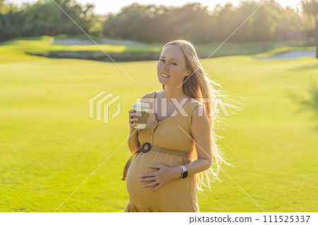 pregnant woman enjoys a cup of coffee outdoors, blending the simple pleasures of nature with the comforting warmth of a beverage during her pregnancy pregnant woman enjoys a cup of coffee outdoors, blending the simple pleasures of nature with the comforting warmth of a beverage during her pregnancy 111525337