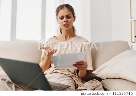 Smiling Woman Working on Laptop in Cozy Home Office Smiling Woman Working on Laptop in Cozy Home Office 111525710