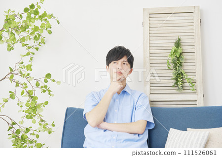 A man thinking in the living room A man thinking in the living room 111526061