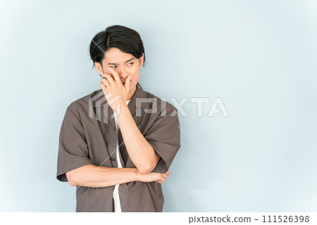 Male model in oversized shirt (hiding, masking, troubled, looking) Male model in oversized shirt (hiding, masking, troubled, looking) 111526398