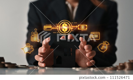 Hands covering house model with virtual icons as property investment, loan and financial plan concept Hands covering house model with virtual icons as property investment, loan and financial plan concept 111526471