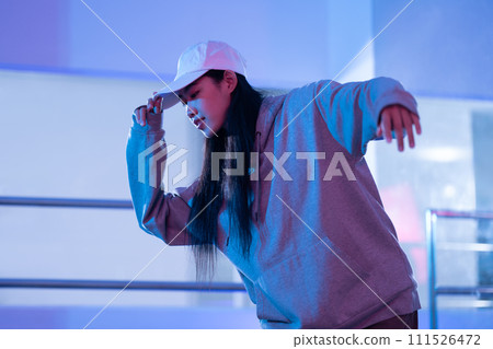 Attractive young woman training hip hop in dance studio. Dance, hobby, movement, and active lifestyle 111526472