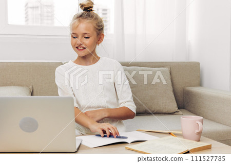 Online schoolgirl lesson homework education child couch school learning distance laptop 111527785