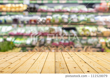 Wood table top with vegetables on grocery store shelves blurred background 111528079
